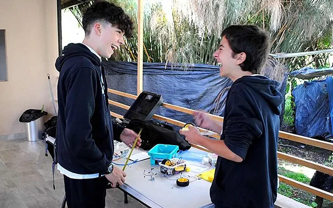 Dos estudiantes armando un proyecto de robótica